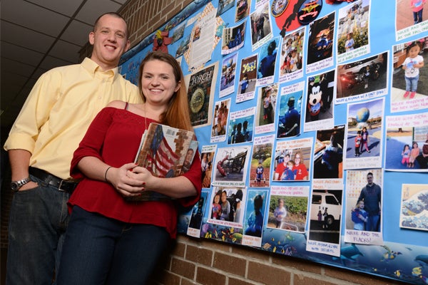 students walking down hallway with books