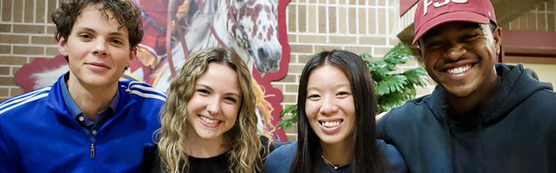 FSU Panama City students smiling together on campus