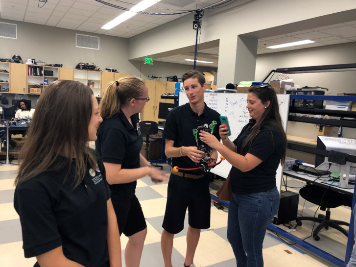 6 MSSE students, Tia Lilliman, Devin Ramsey, Alex Burgans, and Suzy Houser discuss vertical climbing robot at CISCOR.png